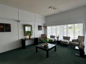 a living room with a couch and a table at Tokaanu Hotel in Tokaanu