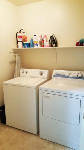 a laundry room with a washing machine and a shelf at Quiet Gated Community Minutes from Falcon Fld in Mesa