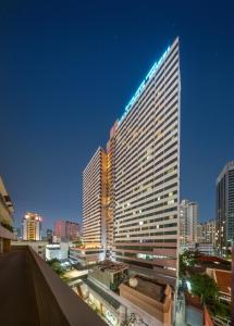 a tall building with a sign on top of it at Royal Benja Hotel - Big Room Family-Friendly in Bangkok +82 photos