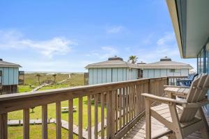 a deck with a rocking chair and a house at Casa Sea-Esta - OCEAN VIEWS in Port Aransas +48 photos
