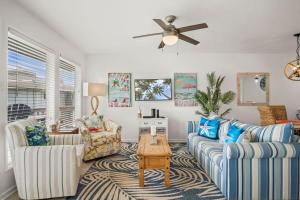 a living room with two couches and a table at Casa Sea-Esta - OCEAN VIEWS in Port Aransas