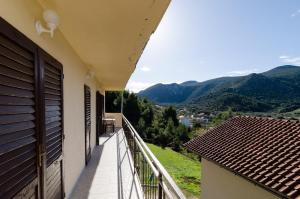 a balcony of a house with a view of mountains at Apartments Dalmatin in Žuljana