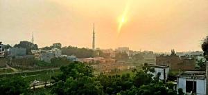 a view of a city with a rainbow in the sky at Varanasi River View Holiday Homestay Dormitory and Hostel in Varanasi