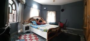 a bedroom with a bed in a blue room at Varanasi River View Holiday Homestay Dormitory and Hostel in Varanasi