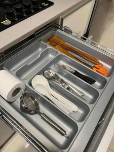 a metal tray with utensils in a kitchen drawer at Full 1 BHK near Aster hospital hebbal in Bangalore +7 photos