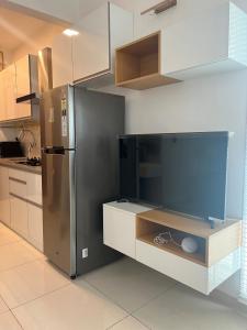 a kitchen with a stainless steel refrigerator and cabinets at Full 1 BHK near Aster hospital hebbal in Bangalore