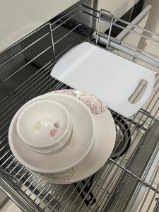 two plates sitting on a rack in a dishwasher at Full 1 BHK near Aster hospital hebbal in Bangalore
