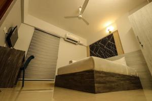 a bed in a room with a ceiling fan at D Mirage Hotels in Cochin +38 photos