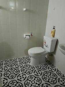 a white bathroom with a toilet and a sink at Homestay Riceberry Ramintha in Ban Baen Phichit +36 photos