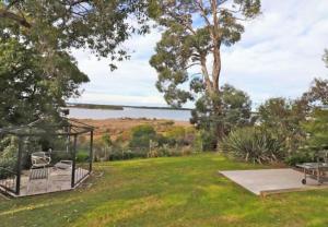 a yard with a gazebo in the grass at 14 Broome Street in Mallacoota