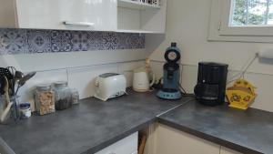 a kitchen counter with various appliances on it at Maison Balzac - 7 personnes quartier calme in Châteauroux