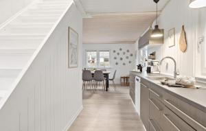 a kitchen with white counters and a dining room at Amazing Home In Haderslev With Wifi in Haderslev