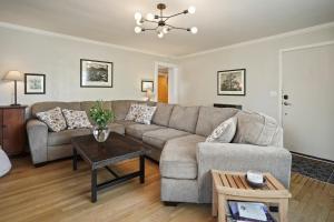 a living room with a couch and a table at NW Nest 30 Day Minimum in Bend