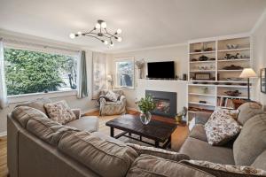 a living room with a couch and a fireplace at NW Nest 30 Day Minimum in Bend