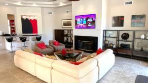 a living room with a white couch and a fireplace at Double Eagle in Rancho Mirage +30 photos