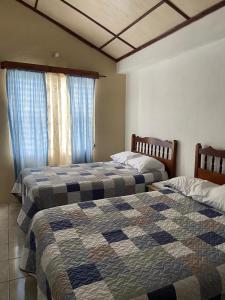 two beds sitting next to each other in a bedroom at Katún boutique hotel in Flores +42 photos