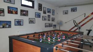 a large foosball table in a room with pictures on the wall at La Craita in Bran