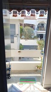 an open door with a view of a balcony at New sharma homestay in Prayagraj