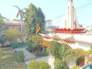 a building with a flag on the side of it at New sharma homestay in Prayagraj