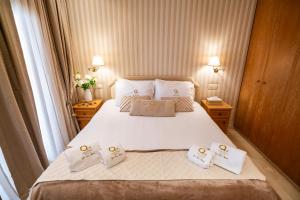 a bedroom with a bed with three pillows on it at Quattro Beachfront Sea View Ap 4 in Larnaka