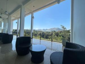 a room with chairs and a balcony with a view at The Marigold Hotel in Gampola +15 photos