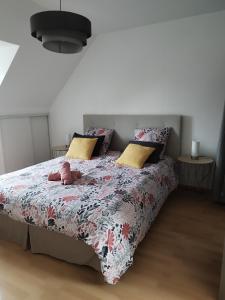 a bedroom with a bed with a stuffed animal on it at Entre Terre et Mer in Saint-Méloir-des-Ondes +37 photos