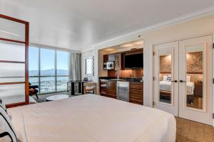 a hotel room with a large bed and a kitchen at The Rosé II MGM Signature Studio Suite Tower 3 in Las Vegas
