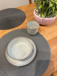 a table with two plates and a bowl on it at Apartamenty U Misia in Stary Sącz