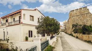 a street in an old town with a castle at Venezian Castle House in Kissamos