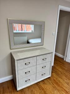 a dresser with a mirror on top of it at Cosy Cloud in Congleton