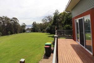 a porch of a house with a field of grass at 19 Blackwood Drive in Mallacoota