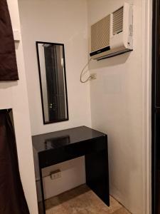 a bathroom with a black desk and a microwave at The Haven Hostel in Boracay