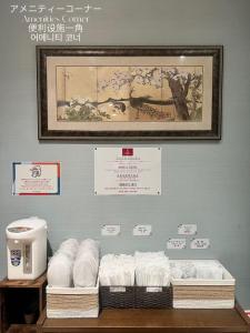 a room with a wall with a bunch of towels at Hotel Arashi Namba No001 in Osaka