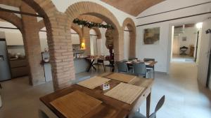 a dining room with arches and a table and chairs at La Torre di Longara in Calderara di Reno