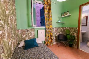a bedroom with a bed and a window and a chair at casa dolce casa new in Rome