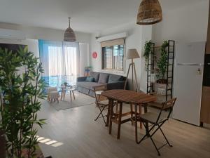 a living room with a table and a couch at Danit apartmnt by the sea in Zygi