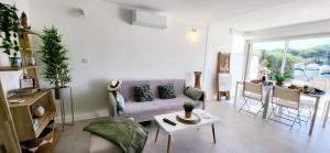 a living room with a couch and a table at MARINA Belle vue avec appontement in Le Grau-du-Roi