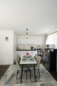 a kitchen with a table and chairs in a room at Arabella Luxe Near Waterfront Mall - Karen in Nairobi