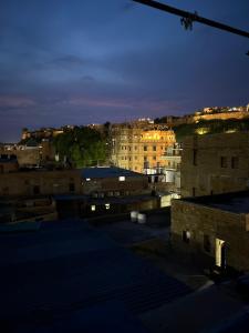 a view of a city at night with buildings at Star View Guest House & Safari in Jaisalmer +23 photos