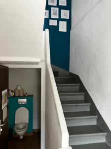 a bathroom with a stairs with a toilet in it at Maison Valence petit jardin in Valence