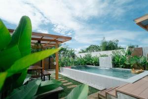 a swimming pool in a garden with plants at Antwans Cabin in Tuy
