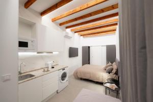 a bedroom with a bed and a sink in a room at Báelia Mini Casa Aurelia in Alicante