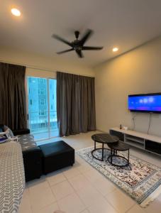 a living room with a couch and a flat screen tv at Aurora’s Homestay Sandakan in Sandakan +6 photos