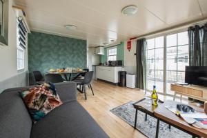 a living room with a couch and a table at 12, Nature, AC, Serenity, Cycling, Hiking & Terraces! in Oisterwijk