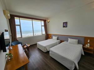 Postel nebo postele na pokoji v ubytování Sammy Hotel