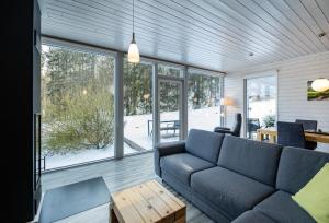 a living room with a couch and a table at 2 Personen mit Sauna F3H7 in Ruhla +11 photos