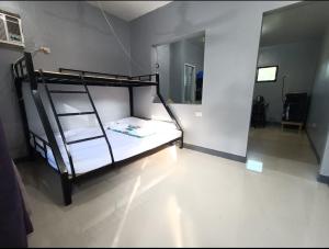 a bedroom with a bunk bed with a ladder at Spy Balay 2x Homestay in Butuan