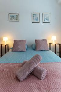 a pair of slippers on top of a bed at Le Roosevelt - Appartement confort hyper centre - Idéal Curiste in Vichy