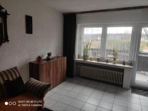 a living room with a couch and a window at Ferienwohnung Daisy in Langerwehe