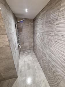 a bathroom with a shower with a glass door at Stunning Modern Riverside Cottage in Aberdulais +25 photos